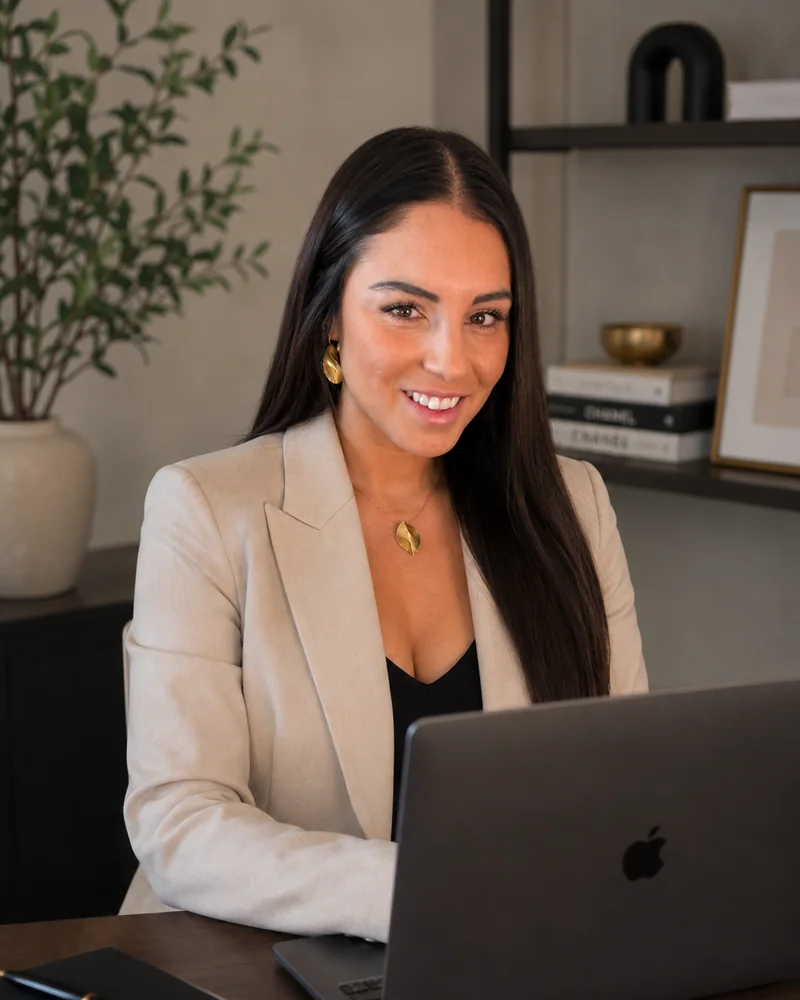Jennifer Asher Cardenas working at her desk in her Orange County studio